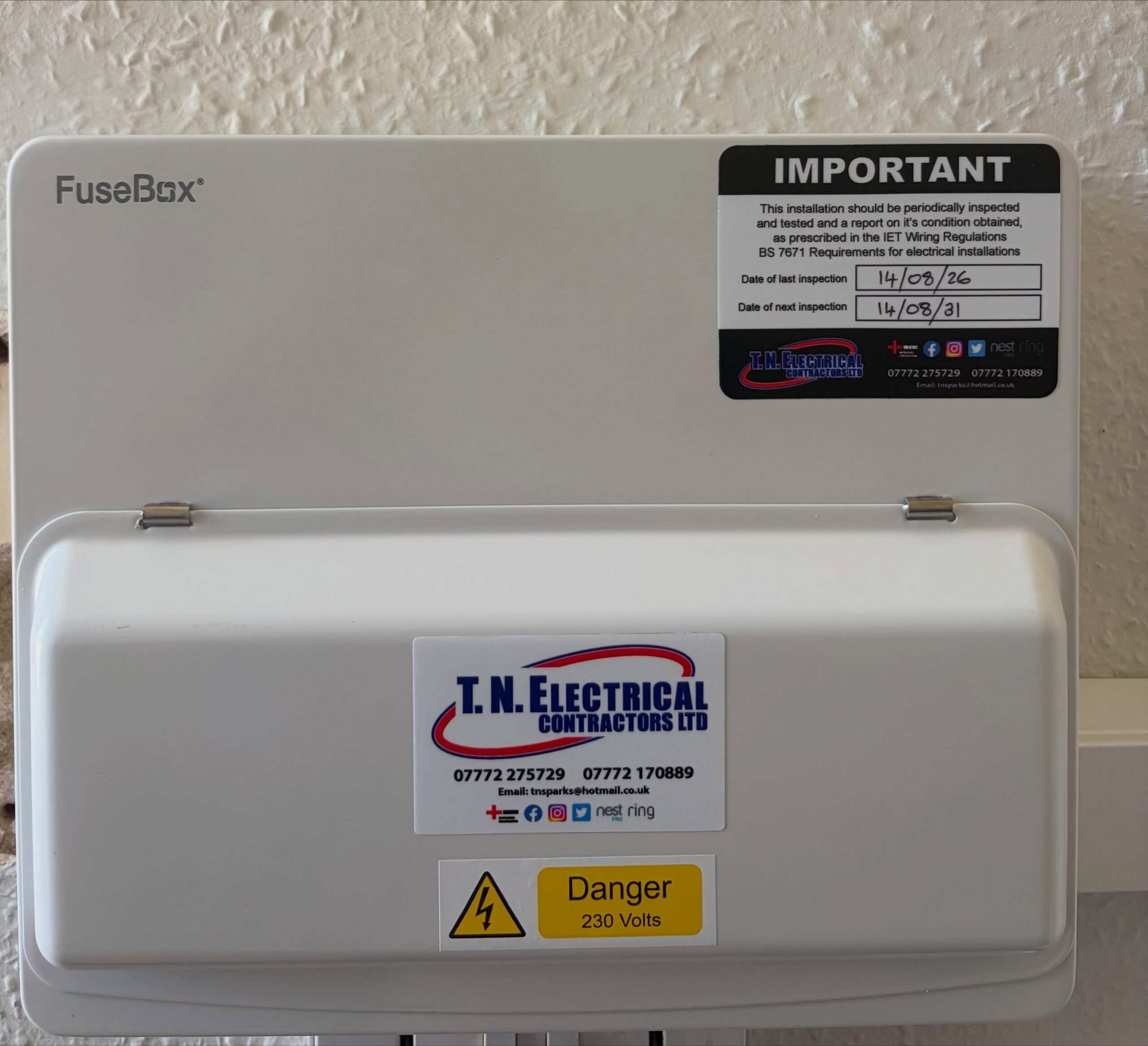 Qualified electrician conducting verification testing on an industrial three-phase distribution board