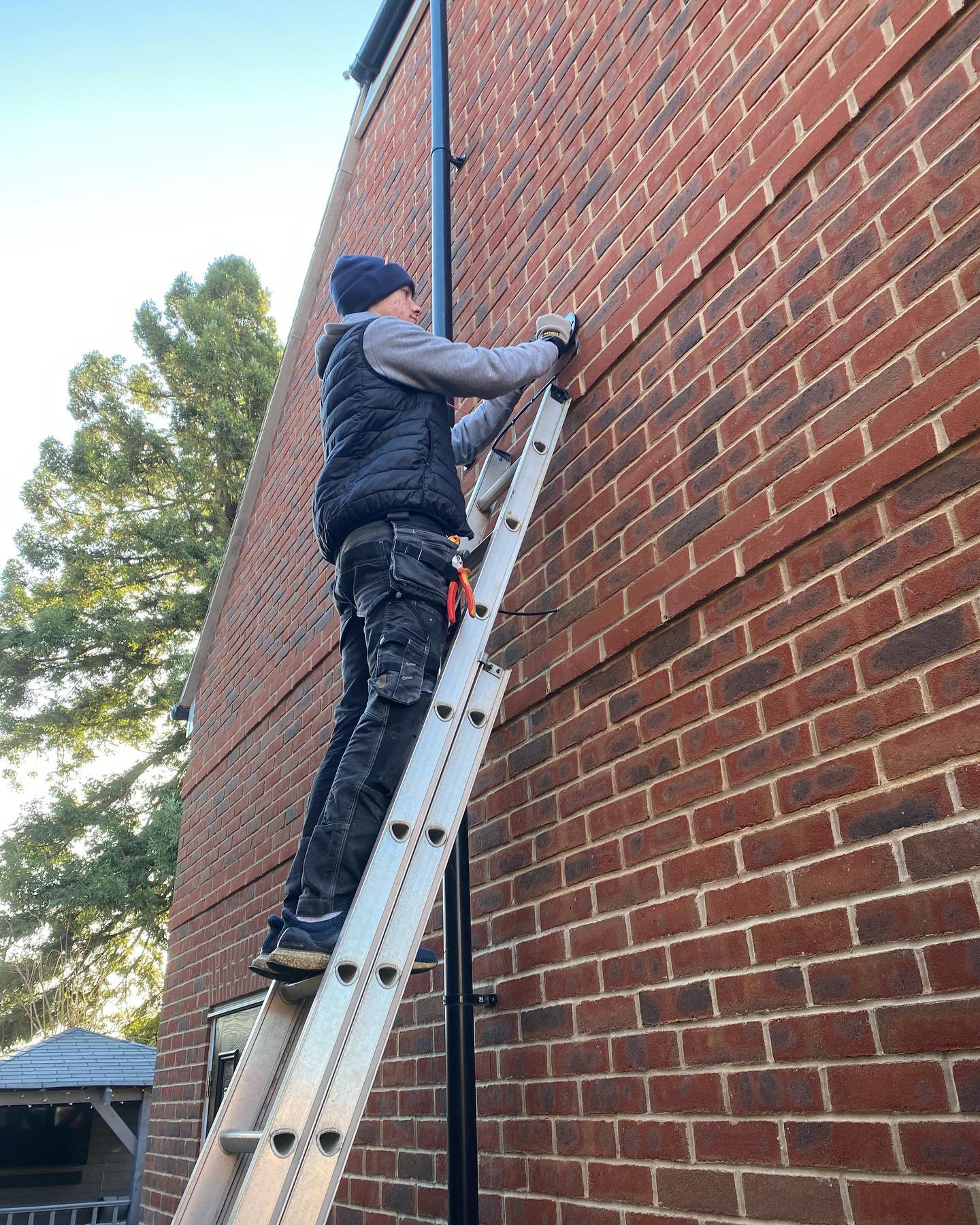 Domestic electrical rewiring installation showing timber framing and clean conduit