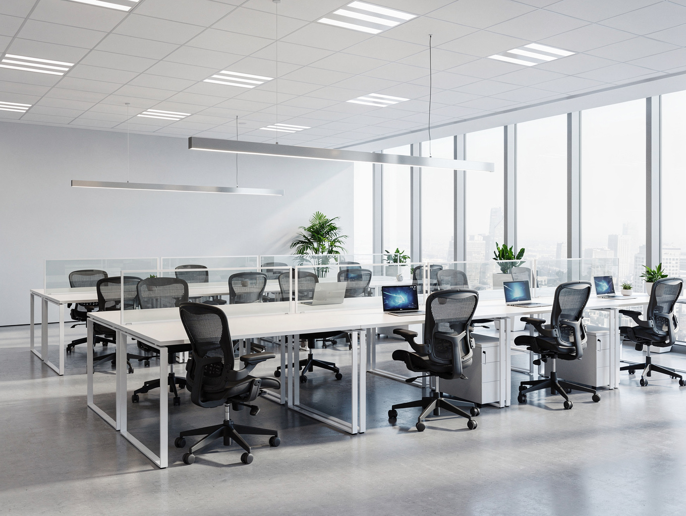 Suspended linear track lighting installed across modern open-plan office desks